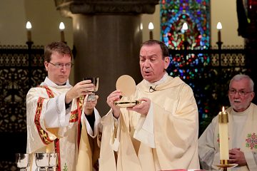 Archbishop Dennis Schnurr prepares the Holy Eucharist for the Mass of Thanksgiving for the 150th Anniversary of the Arrival of the Little Sisters of the Poor in Cincinnati at St. Monica-St. George Parish in Cincinnati Saturday, Oct. 20, 2018. (CT Photo/E.L. Hubbard)