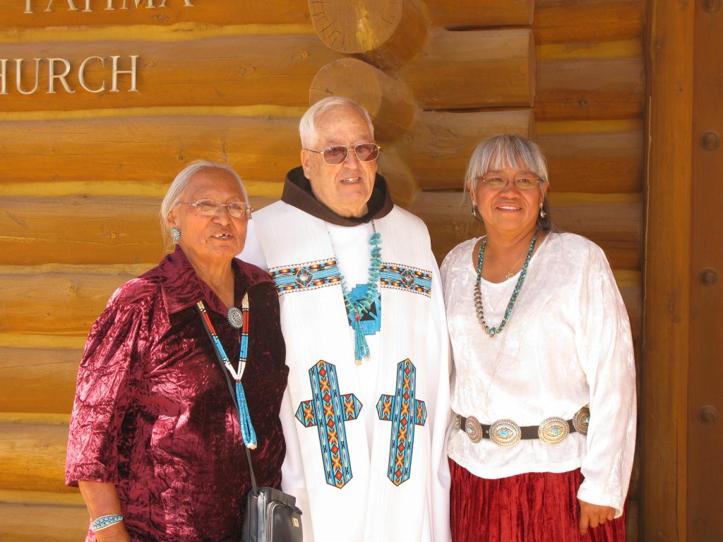 Franciscan Father Blaine Grein poses with parishioners in Chinle, Ariz., where he served from 1978-2012. (Courtesy Photo)