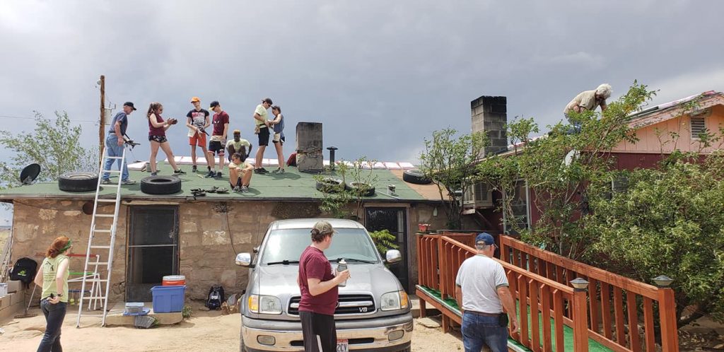 Youth and their chaperone from Cincinnati work on the roof of a Navajo home. (Courtesy Photo)