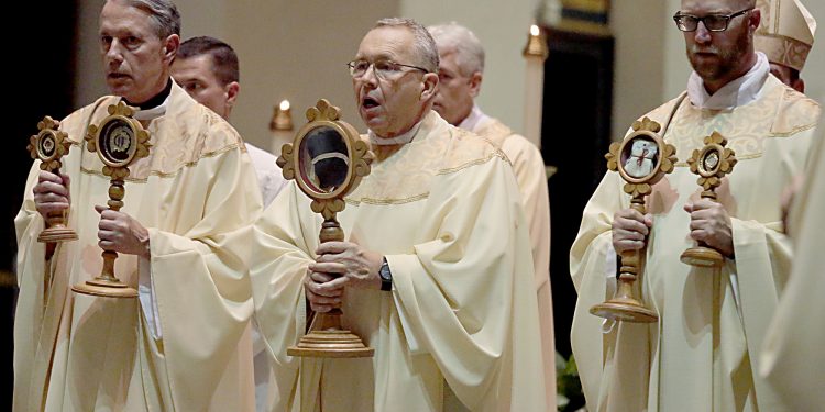 Fr. Raymond Larger, Fr. Jan Schmidt, and Fr. Kyle Schnippel carry the Relics during Mass and Veneration of the Relics of Saint Pio of Pietrelcine, O.F.M Cap, at Saint Peter in Chains Cathedral in Cincinnati Wednesday, Oct. 3, 2018. (CT Photo/E.L. Hubbard)