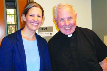 Cheri Champagne, Catholic coordinator at Our Lady Queen of Peace Parish on Wright-Patterson AFB, poses with Father Donald Moss, pastor. (Courtesy Photo)