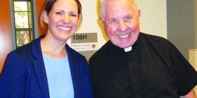 Cheri Champagne, Catholic coordinator at Our Lady Queen of Peace Parish on Wright-Patterson AFB, poses with Father Donald Moss, pastor. (Courtesy Photo)