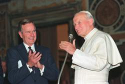 U.S. President George H.W. Bush applauds St. John Paul II after a welcoming ceremony prior to their audience at the Vatican in 1991. Bush, the 41st president of the United States and the father of the 43rd, died Nov. 30 at his home in Houston. He was 94. (CNS photo/Rick Wilking, Reuters)