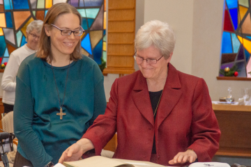 Sister Carol Lichtenberg, Provincial, and Sister Sarah Cieplinski sign the official register of Perpetual Vows, indicating Sarah’s gift of her complete life to God. (Courtesy Photo)