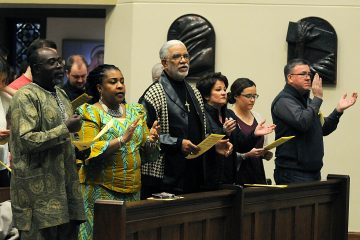 Members of the congregation sing the "Gathering Hymn" during the Unversity of Dayton's "Mass in Celebration of Black History Month" in the Chapel of the Immaculate Conception on Sunday, Feb. 10. (CT Photo/David Moodie)