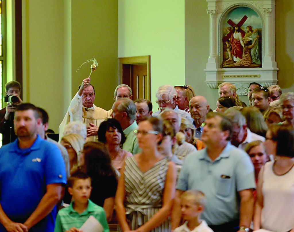Archbishop Dennis Schnurr sprinkles the new church during the dedication of St. John the Baptist Church in Harrison Saturday, June 1, 2019. (CT Photo/E.L. Hubbard)