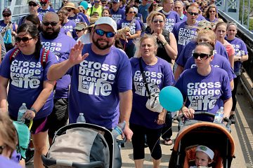 People cross the Purple People Bridge during the Cross the Bridge for Life in Newport, Ky. Sunday, June 2, 2019. (CT Photo/E.L. Hubbard)