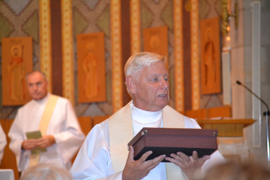 Father David Brinkmoeller concelebrates Mass at the Grotto in Lourdes on the Marian Pilgramage in 2017. Father Brinkmoeller is on the far left. (CT Photo/Greg Hartman)