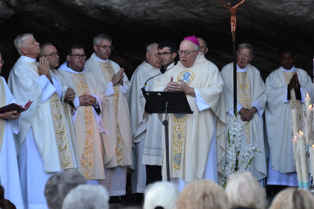 Father David Brinkmoeller concelebrates Mass at the Grotto in Lourdes, France. Father David is on the far left. (CT Photo/Greg Hartman)