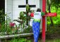 Antonia Silva Lima, a farmer in the Brazilian Amazon, prays at the grave of U.S.-born Sister Dorothy Stang in Anapu, Brazil. Sister Stang was assassinated in 2005. The red cross beside her grave bears the names of 16 local rights activists who have been murdered since her killing. Church activists say the killings continue, and they're about to erect a second red cross with even more names. (CNS Photo/Paul Jeffrey)