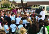 Queen of Peace Parish in Hamilton replaced their outside cross atop the church that was originally built and erected in 1966. The new cross is larger and lit for the entire Queen Acres neighborhood. They placed the old cross inside the new one. Students witnessed the blessing of the new cross.