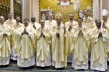 Front Row from L to R: Father Anthony Brausch, Father Mark Bredstege, Father Jeff Stegbauer, Archbishop Dennis M. Schnurr, Father Andrew Hess, Father Alex Biryomumeisho; Back Row L to R, Father Ambrose Dobrozsi, Father Elias Mwesigye, Father Zach Cecil, Father Jedidiah Tritle, Father Christian Cone-Lombarte, and Bishop Joseph Binzer (CT Photo/Greg Hartman)