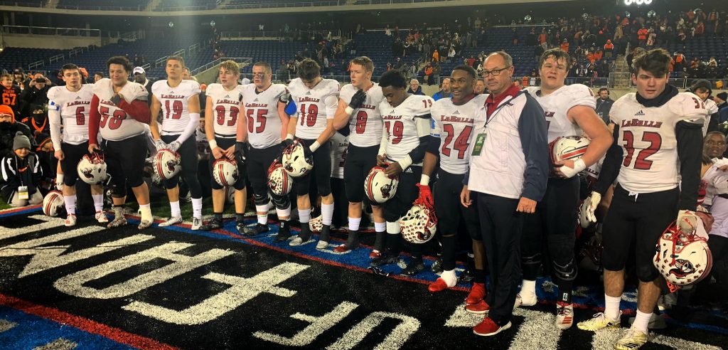 Coach Pat McLaughlin and squad ready to accept the trophy.