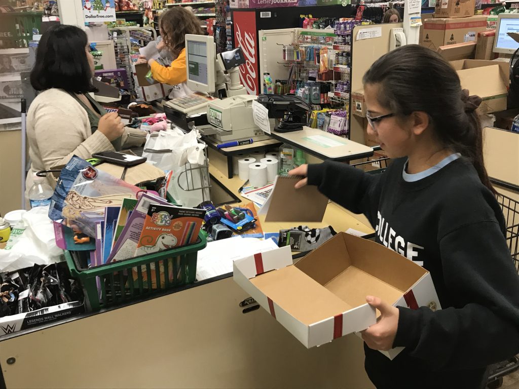 Claes purchases supplies to fill Boxes of Joy, a ministry of Cross Catholic Outreach.