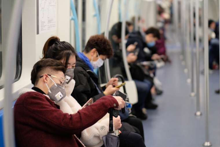 People wearing surgical mask sitting in subway in Shanghai, China. Credit: Robert Wei/Shutterstock
