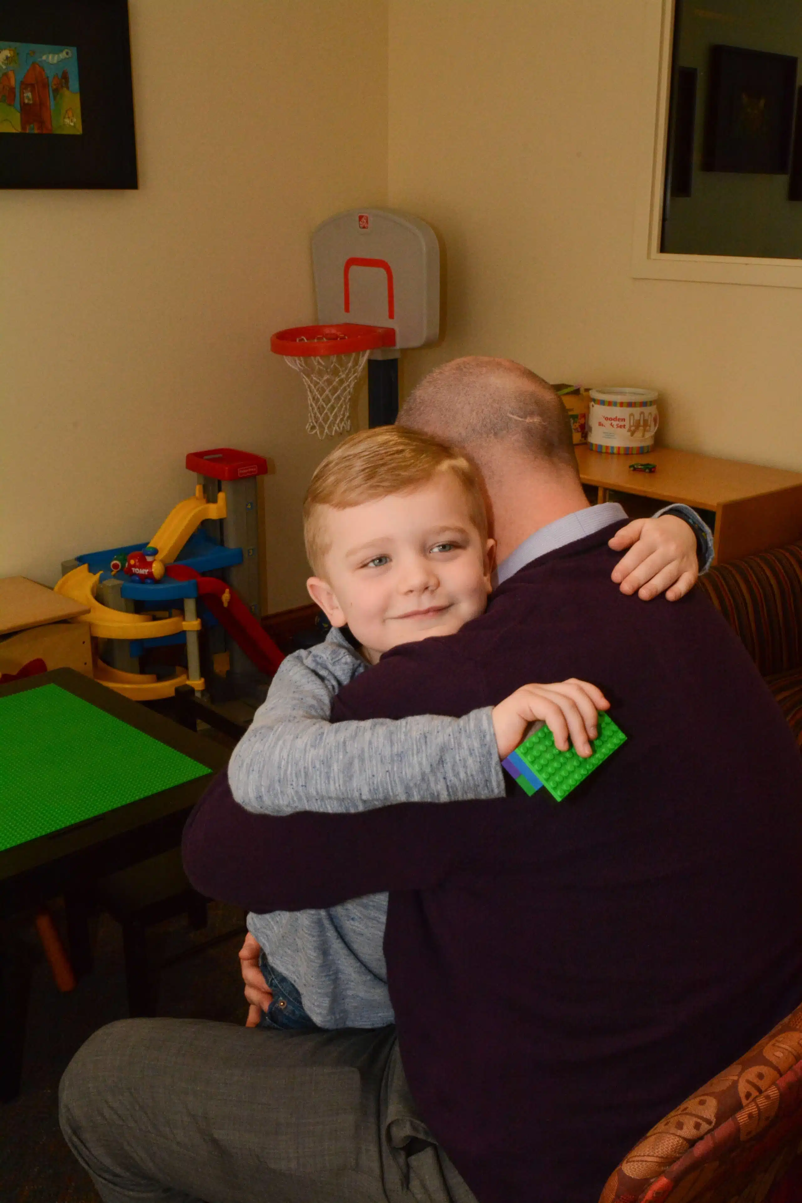Young boy hugging father