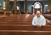 David Cooley, editorial director of The Catholic Telegraph, prays the Rosary at St. Xavier Church