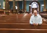 David Cooley, editorial director of The Catholic Telegraph, prays the Rosary at St. Xavier Church