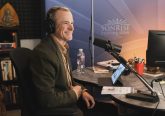 Man smiling with headphones on radio