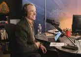 Man smiling with headphones on radio