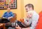 Man holding child on his lap while supervised